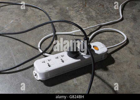 Erhöhte Ansicht von Kabeln verbunden elektrische Stecker am Boden Stockfoto