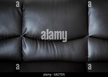 schwarzes Ledersofa hautnah und texturiert und Hintergrund mit Raum. Stockfoto