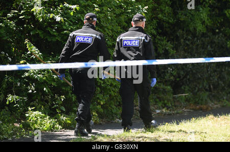 Polizisten gehen nach der Suche nach Beweisen einen Fußweg entlang Wo der Leichnam des vermissten Mädchens Amber Peat gefunden wurde Stockfoto