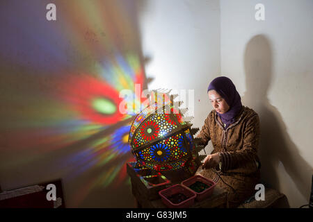 Ein Handwerker schafft traditionelle Leuchten in ihrem Atelier in Fez, Marokko. Stockfoto