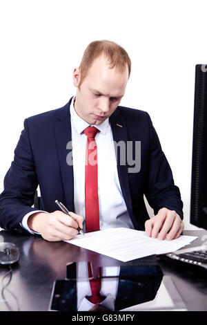 Geschäftsmann signiert Dokumente am Arbeitsplatz. Stockfoto
