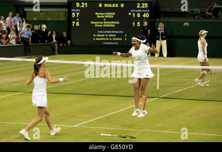 Martina Hingis (links) und Sania Mirza feiern den Sieg im Damendoppel-Finale am 12. Tag der Wimbledon Championships im All England Lawn Tennis and Croquet Club in Wimbledon. Stockfoto