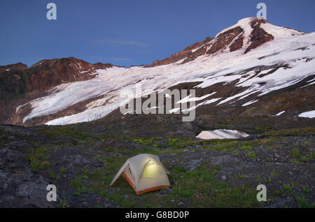 Zelt beleuchtet in der Abenddämmerung auf Kletterer Camp an den Hängen des Heliotrops Ridge, Mount Baker Wildnis North Cascades Washington Stockfoto