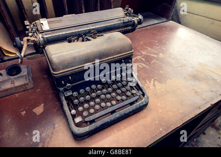 Vintage Schreibmaschine auf dem Schreibtisch platziert. Farbe-toning angewendet Stockfoto