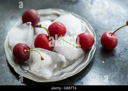 Köstliche rote Süßkirschen mit Eiswürfeln Stockfoto