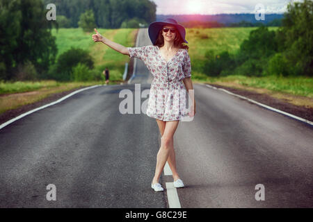 Mädchen-Reisen auf der Autobahn Trampen Stockfoto