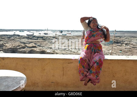 eine indische Frau in Saree posiert am Strand in der Slum-Gegend von Chimbai Dorf, Bandra, Mumbai, Indien Stockfoto