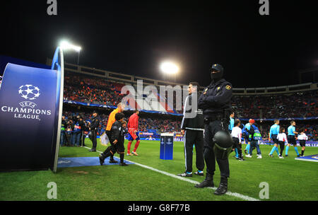 Die bewaffnete Polizei steht auf dem Spielfeld, als die Spieler von Atletico Madrid und Galatasaray vor dem UEFA Champions League-Spiel das Estadio Vicente Calderon betreten Stockfoto