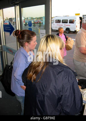 Die beiden Freunde von Kelly Ann Piggford verlassen das Terminal des Flughafens Durham Tees Valley. Lisa Riding (rechts), 20, und ihre namenlose Gefährtin waren gerade mit Miss Piggford nach einem zweiwöchigen Urlaub in der Türkei nach Großbritannien zurückgekehrt. Miss Piggford, 23, aus Darlington, County Durham, hatte ihre Kinder zu Hause gelassen, um mit ihren zwei Freunden in den Urlaub im türkischen Ferienort Marmaris zu gehen. Sie wurde zu einem Seiteneingang am Flughafen begleitet, um nicht auf Journalisten zu warten. Stockfoto