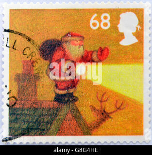 Vereinigtes Königreich - ca. 2004: Eine Briefmarke gedruckt in Großbritannien zeigt Bild von Santa Claus, im Nebel am Rand des Daches mit Fackel, cir Stockfoto