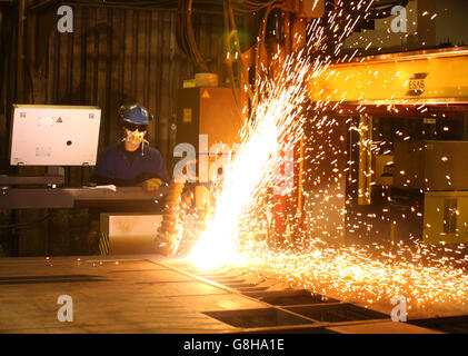 Ein Brenner verwendet einen Plasmaschneider, um Stahlplatten an Watson Towers in Coatbridge zu schneiden, um in die spezifischen Komponenten zu schneiden, die das Ende des Fachwerks auf der Forth Road Bridge fixieren. Stockfoto
