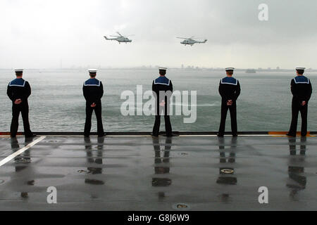 Zwei Lynx-Hubschrauber führen einen Flypast durch, als das ehemalige Flaggschiff der Royal Navy, HMS Invincible, zum letzten Mal nach Portsmouth segelt, bevor es außer Dienst gestellt wird. Die Fluggesellschaft, die 1977 eingeführt wurde, wird sechs Monate früher außer Betrieb genommen. Ein Schritt Kritiker schlagen vor, ist eine Kostenreduzierung Operation zur Finanzierung der laufenden Irak-Krieg und wird an die mod's Disposal and Reserve Ships Organisation übergeben werden, die es motthball, bis es im Jahr 2010 verkauft wird. Stockfoto