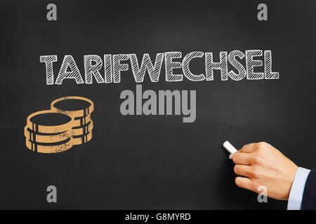 Hand schreibt in deutscher Sprache "Tarifwechsel" (Tarif ändern) an Tafel Stockfoto