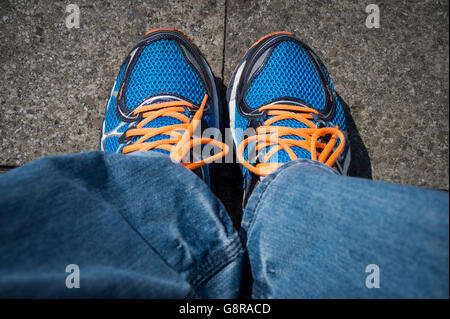 paar blau Laufschuhe mit orangefarbenen Schnürsenkeln Stockfoto