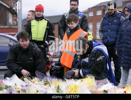 Mitglieder eines schottischen Motorradclubs, darunter Colin Lawrie (vorne rechts) mit seinem Sohn Cailean (vorne in der Mitte), 11, zollen den Blumen, die Asad Shah vor seinem Geschäft in Shawlands, Glasgow, hinterlassen wurden, ihren Respekt. Als zweite Mahnwache wurde für den angesehenen muslimischen Ladenbesitzer gehalten, der bei einem von der Polizei als „religiös voreingenommen“ behandelten Angriff getötet wurde. Stockfoto