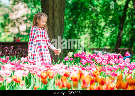 Entzückende Mädchen in blühenden Tulpen Garten. Ausstellung von verschiedenen Sorten von Tulpen im Park im freien Stockfoto