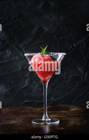 Gezuckert Cocktailglas Erdbeer Dessert, serviert auf dunklem Hintergrund mit frischer Minze-Sorbet. Mit Textfreiraum. Stockfoto