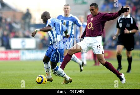 Henri Camara von Wigan Athletic wird von Gilberto Silva von Arsenal herausgefordert Stockfoto