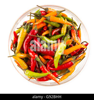 Schüssel mit gelben, roten und grünen scharfe Chilischoten isoliert auf weiss.  Ansicht von oben. Stockfoto