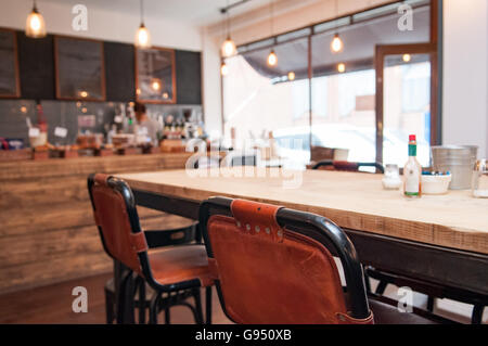 Innenministerium eine rustikale Coffee-Shop mit einem großen Holztisch im Vordergrund Stockfoto