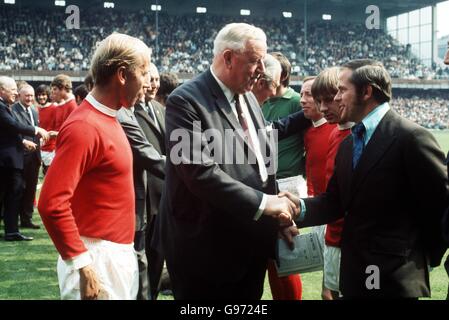 Fußball - Watney Cup - Finale - Derby County / Manchester United. Wilf McGuinness (rechts), Manager von Manchester United, schüttelt Sir Stanley Rous (Mitte) die Hände, während Bobby Charlton (links) zuschaut Stockfoto