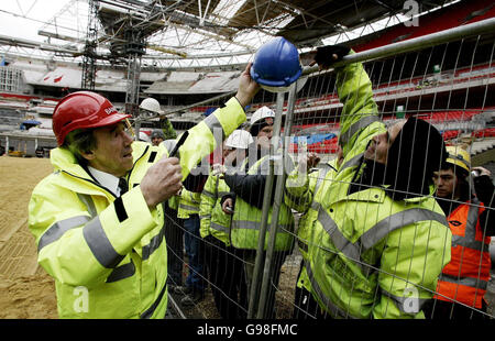 Gordon Banks MBE gibt einem Baumeister im Wembley Stadium einen Hut zurück, nachdem er ihn am Dienstag, den 21. März 2006, unterzeichnet hat. Sieben der 1966 in England siegreichen WM-Teams sind an den Schauplatz ihres Sieges in Wembley zurückgekehrt - zusammen mit 11 Mitgliedern des westdeutschen Kaders, die sie geschlagen haben, um die Trophäe zu holen. Die Veranstaltung wurde anlässlich des 40. Jahrestages der größten Leistung des englischen Fußballs organisiert und mit der Vorfreude auf die Fußballweltmeisterschaft in Deutschland in diesem Sommer. Siehe PA Story SPORT England. DRÜCKEN SIE VERBANDSFOTO. Bildnachweis sollte lauten: Andrew Parsons/PA Stockfoto