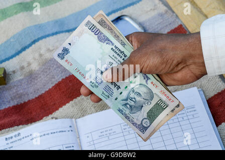 Indien, Madhya Pradesh, Landfrauen Bank im Dorf, hundert Rupien-Banknote mit Bild von Mahatma Gandhi Stockfoto