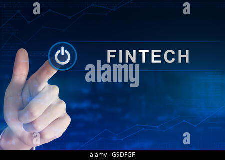 Doppelbelichtung Business Hand anklicken Fintech oder Finanztechnologie Knopf mit unscharfen Hintergrund Stockfoto