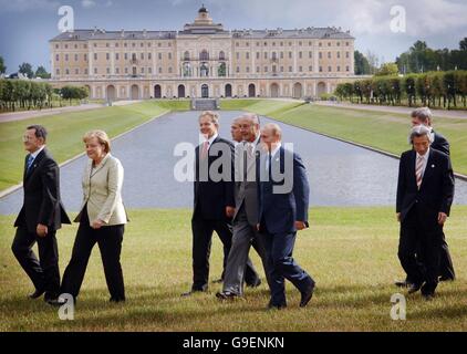 G8-Führer (von links nach rechts): Romano Prodi (Italien), Angela Merkel (Deutschland), Tony Blair (Großbritannien), George Bush (USA), Jacques Chirac (Frankreich), Vladimir Putin (Russland), Junichiro Koizumi (Japan) und Stephen Harper (Kanada) verlassen das Land, nachdem sie auf dem G8-Gipfel in St. Petersburg, Russland, für ein Familienfoto posiert haben. Stockfoto