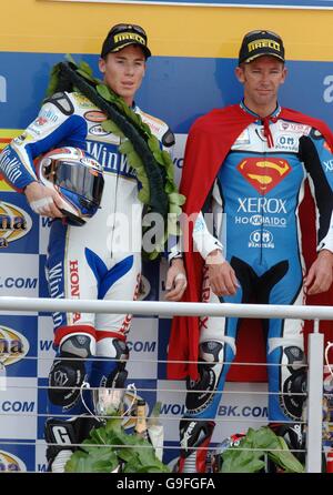 Der australische Troy Bayliss feiert mit dem britischen James Toseland (L) auf dem Podium, nachdem er das erste Rennen während der achten Runde der Superbike-Weltmeisterschaft in Brands Hatch gewonnen hatte. Stockfoto