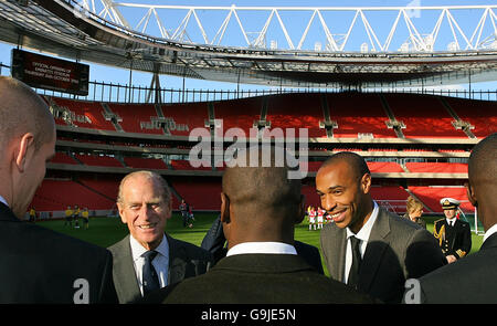 Der britische Prinz Philip (2. L) wird von Thierry Henry (R) bei der offiziellen Eröffnung des Emirates Stadium in London am 26. Oktober 2006 in die Mannschaft des Arsenal eingeführt. Prinz Philip nahm allein am Donnerstag an der Veranstaltung Teil, nachdem Königin Elizabeth II. Den Besuch im neuen Stadion des englischen Premiership-Fußballvereins Arsenal aufgrund einer angespannten Rückenmuskulatur abgesagt hatte, teilte ihr Büro mit. Die 80-jährige Monarchin - seit 1952 auf dem Thron - hatte in Begleitung ihres 85-jährigen Mannes Prinz Philip das neue Emirates Stadium der Gunners im Norden Londons offiziell eröffnen sollen. Eine Sprecherin ihres offiziellen London Stockfoto