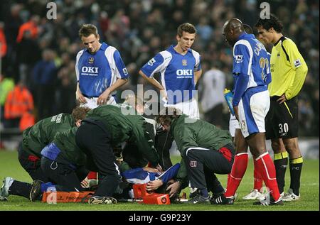 Miguel Pedro Mendes von Portsmouth wird nach einer Herausforderung verletzt Joey Barton von Manchester City (nicht im Bild) Stockfoto