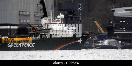 Das Greenpeace-Schiff Arctic Sunrise liegt neben dem Atom-U-Boot HMS Vigilant, das an der Faslane Naval Base in Schottland angedockt ist. Stockfoto