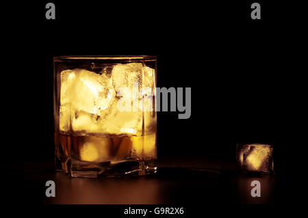 Whisky mit Eiswürfeln in warmen Tönen Stockfoto