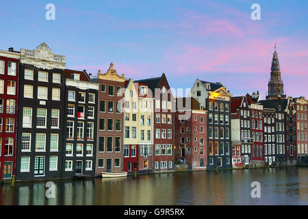 Traditionelle Häuser auf dem Damrak Kanal in Amsterdam, Holland Stockfoto