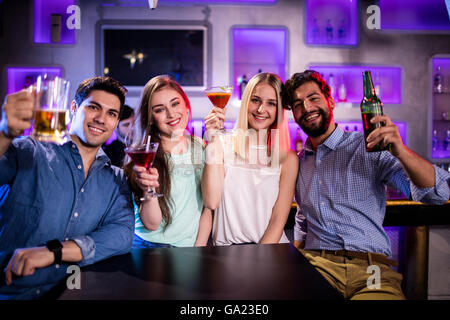 Gruppe von Freunden zeigen, cocktail, Bierflasche und Bierglas am Tresen Stockfoto