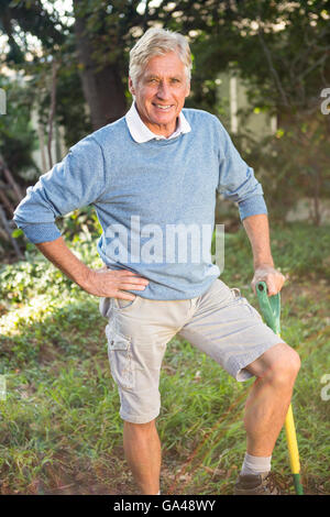 Porträt von glücklich Gärtner mit Werkzeug stehen im Garten Stockfoto