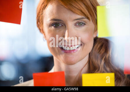 Porträt der hübsche Geschäftsfrau durch Glas gesehen Stockfoto