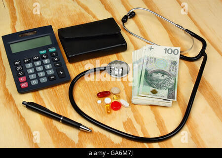 Pillen, Tabletten, Taschenrechner, Geldbörse, Stift und Stethoskop auf hölzernen Hintergrund Stockfoto
