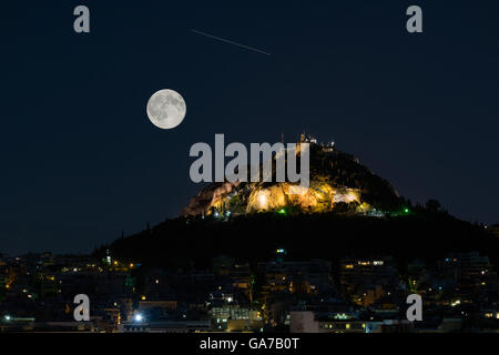 Lycabettus Berg in Athen gegen die August-Vollmond und eine Sternschnuppe. Stockfoto