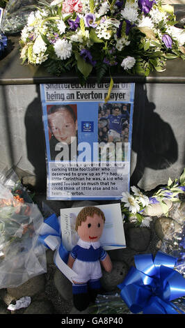 Blumengebete, die vor Evertons Fußballplatz an der Dixie Dean-Statue für den ermordeten Schuljungen Rhys Jones gelegt wurden. Stockfoto