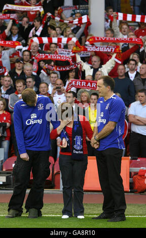 Die Eltern des ermordeten Schuljungen Rhys Jones, Melanie (Mitte) und Stephen Jones (rechts), stehen mit ihrem älteren Sohn Owen (links), als die Everton Fußballclubhymne Z Cars vor dem Champions League Third Qualifying Round Second Leg Match in Anfield, Liverpool, zwischen Liverpool und Toulouse gespielt wird. Stockfoto