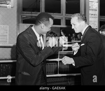 Der britische und Commonwealth-Schwergewichtssieger Henry Cooper, rechts, steht mit dem Sänger Harry Belafonte, links, im Ring des Thomas A'Beckett-Fitnessstudios. Stockfoto