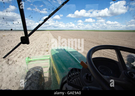 Hinter dem Lenkrad eines Traktors auf das Feld anzeigen Stockfoto