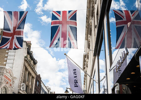 Union Jacks fliegen außerhalb Prada auf Old Bond Street in London Mayfair Bereich, UK Stockfoto