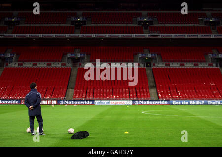 England-Manager Fabio Capello blickt während einer Trainingseinheit auf ein leeres Wembley-Stadion. Stockfoto