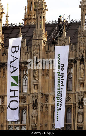 Demonstranten hängen Transparente vom Dach der Houses of Parliament, die gegen die Erweiterung des Flughafens Heathrow demonstrieren. Stockfoto