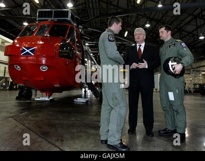 Verteidigungsminister des Browne spricht mit Piloten Leutnant James Bullock (links) und Zweiter im Kommando bei HMS Gannet Leutnant Martin Lanni (rechts) während des Besuchs des Ministers bei der geschäftigsten Such- und Rettungshubschrauberstation der Royal Navy, HMS Gannet in Prestwick. Stockfoto