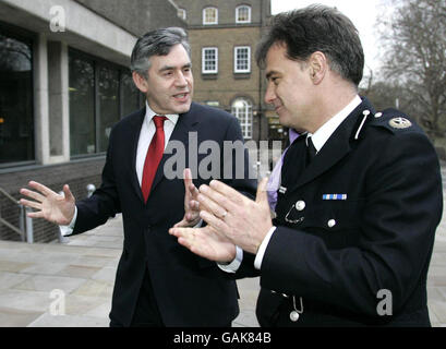 Premierminister Gordon Brown spricht mit Kommandant Simon Foy, als er zu einem Besuch beim Metropolitan Police Central Communications Command in London eintrifft. Stockfoto