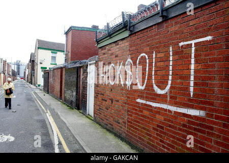 Eine Frau geht an Graffitti in der Nähe des Stadions des Fußballvereins Liverpool vorbei und zeigt die Unruhe der Fans über den amerikanischen Besitz des Clubs. Stockfoto